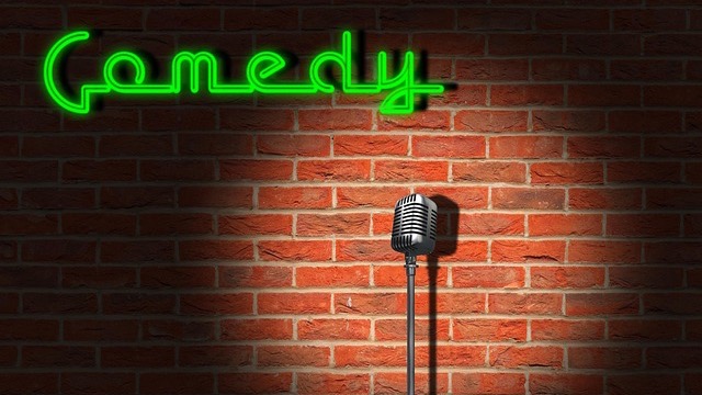Comedy club stage with microphone and neon sign at the 11th Annual Battle of the Improv All-Stars Omaha.