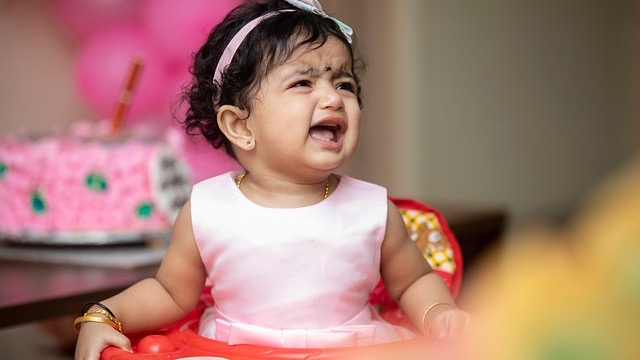 Toddler behavior tips podcast with host talking on a microphone.