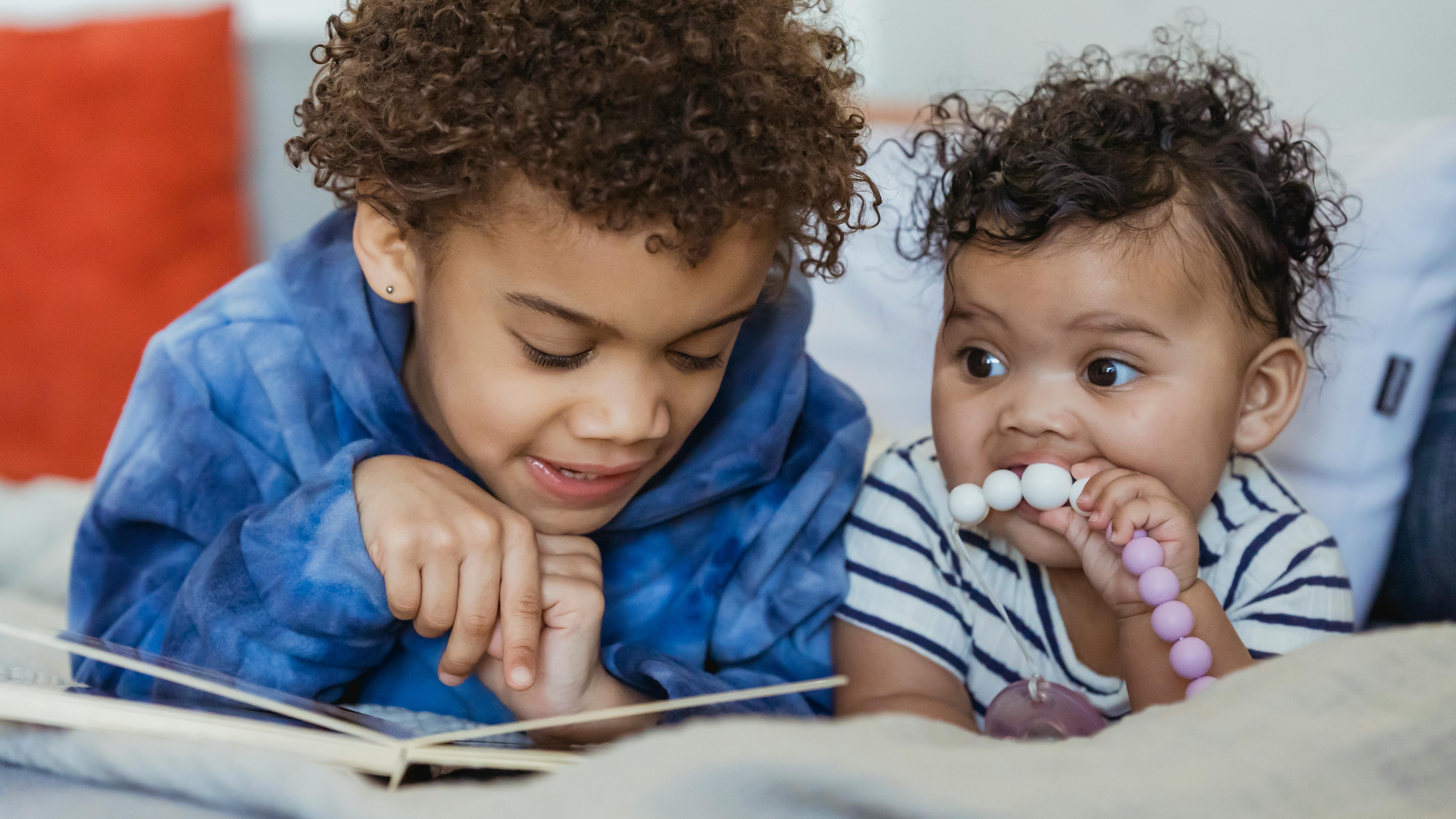 Joyful toddler engaging with a colorful busy book.