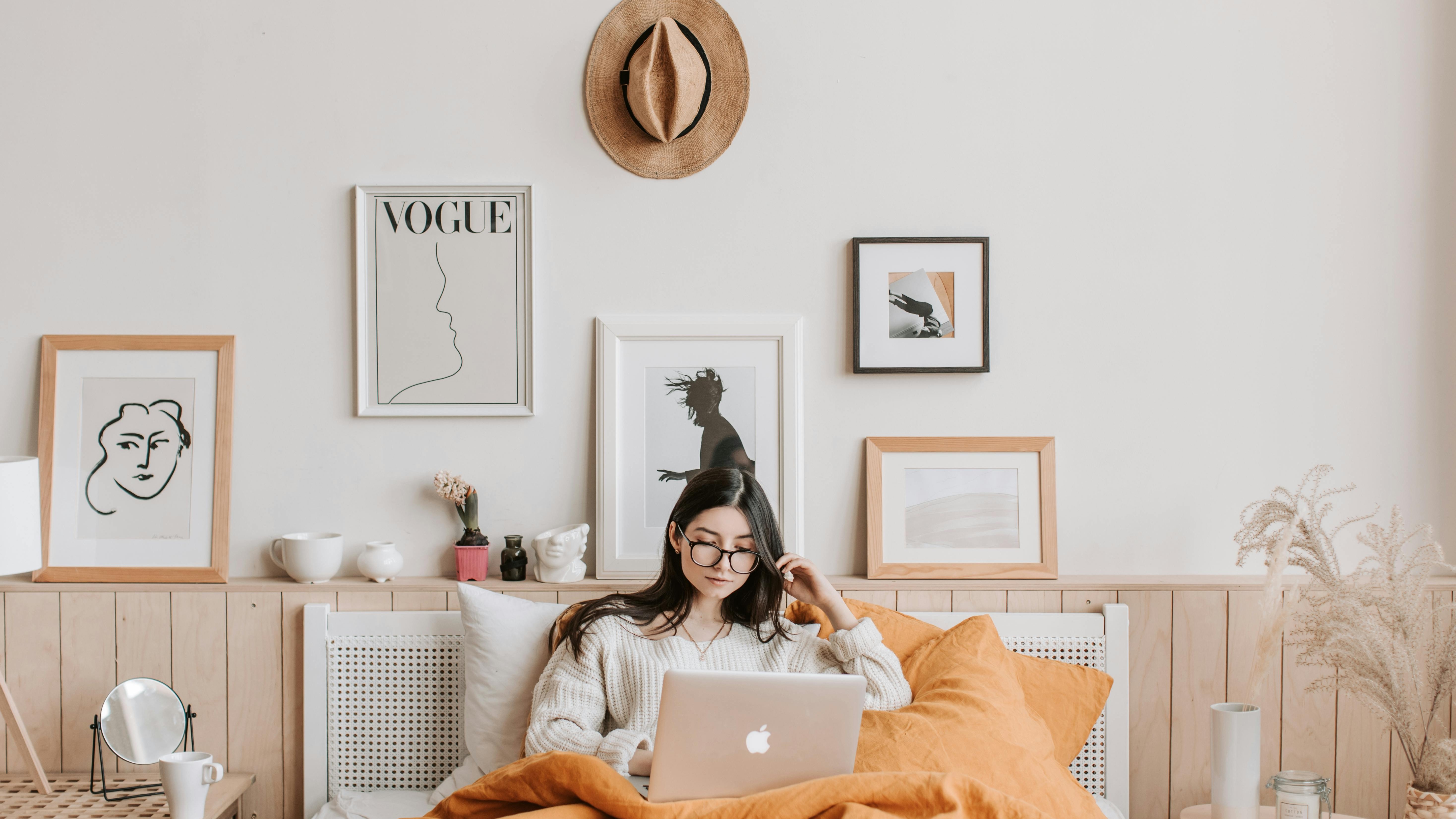 Modern long living room layout with eclectic decor and vibrant armchair.