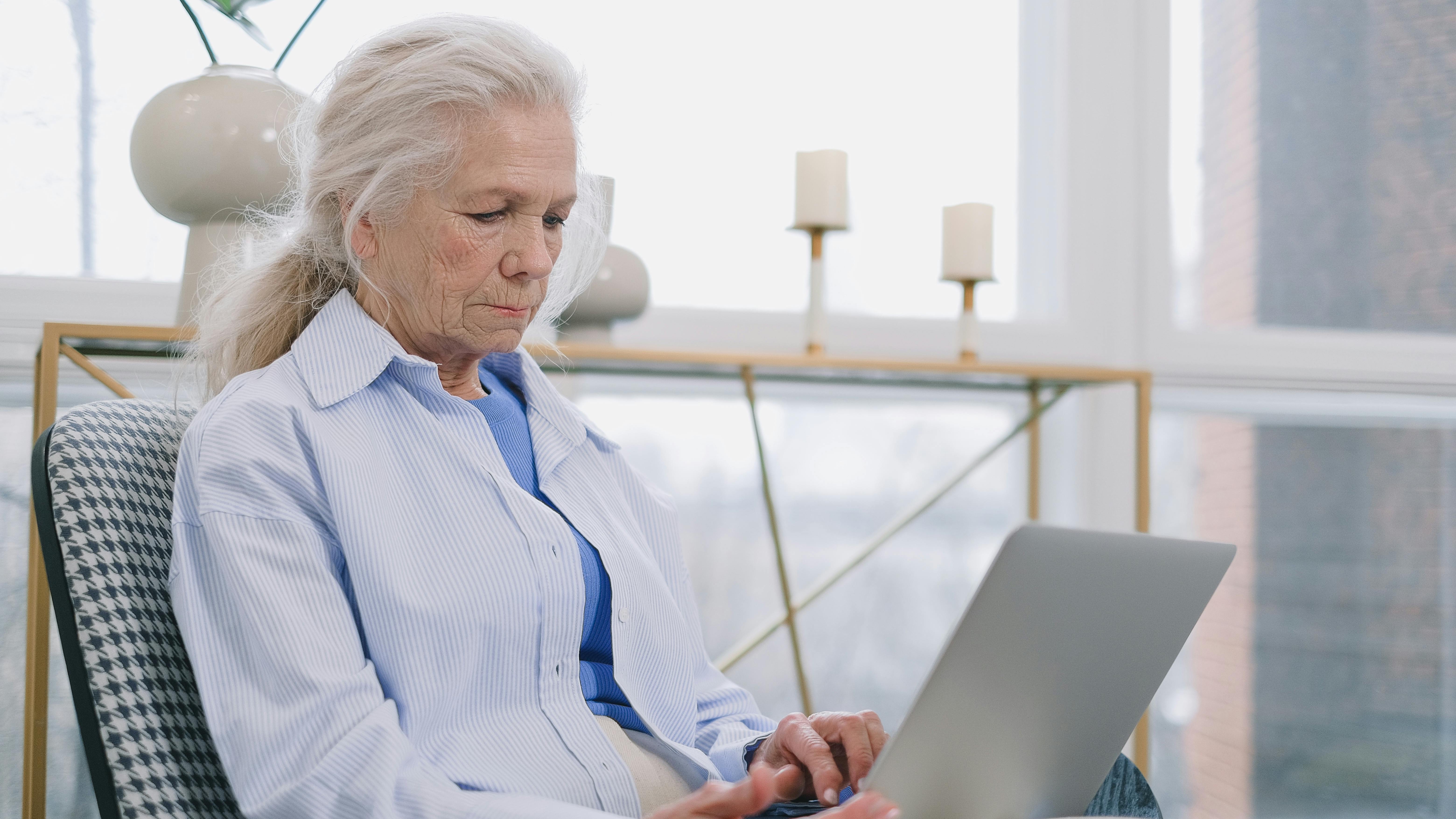 Diverse group of seniors using laptops in a bright office, San Antonio.