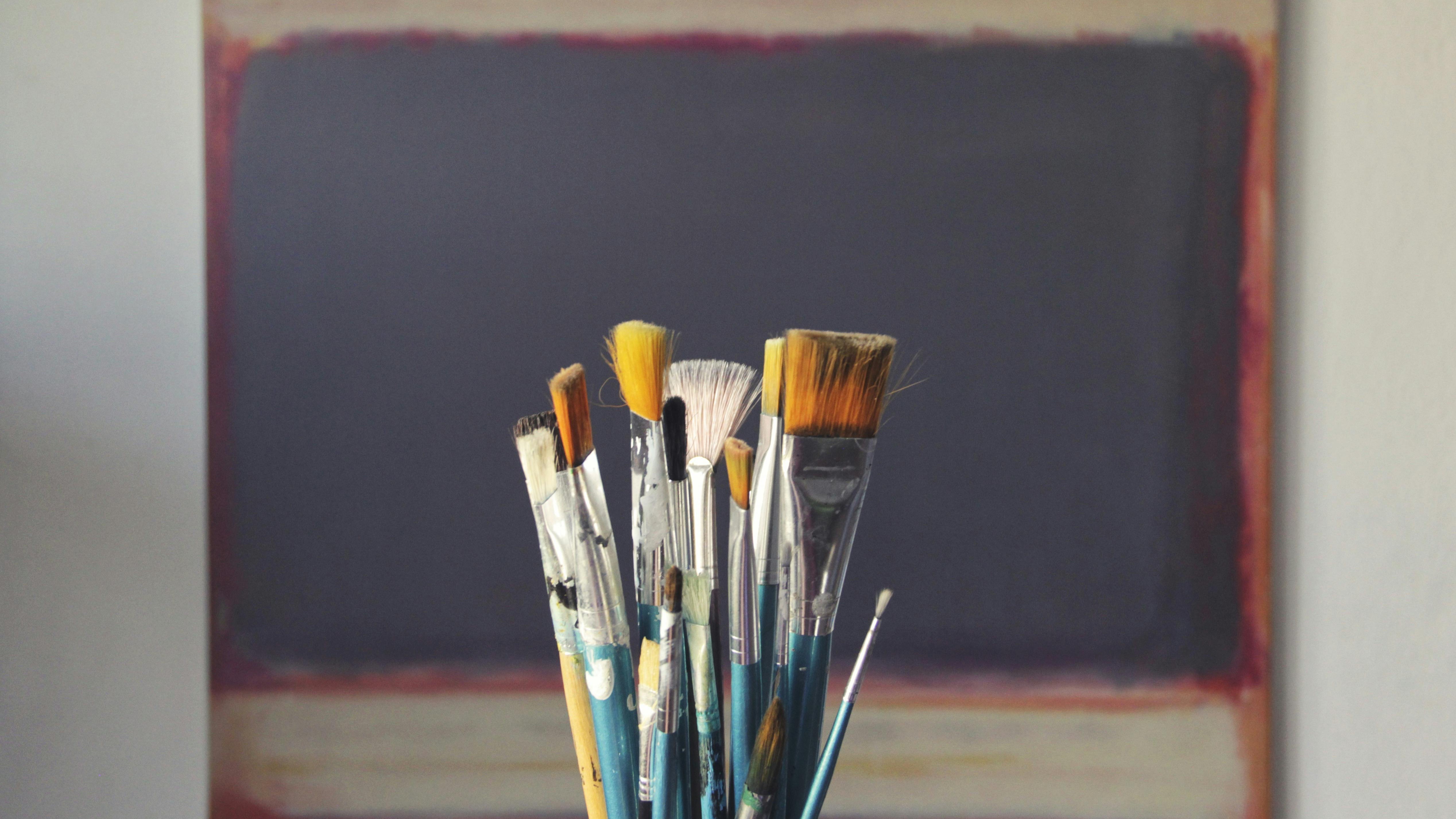 Thoughtful man indoors near wooden panel, AI-generated video creators.