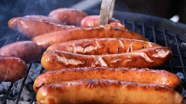 Tasty barbecue meal with brisket, sausage, beans, and bread at a San Antonio restaurant.