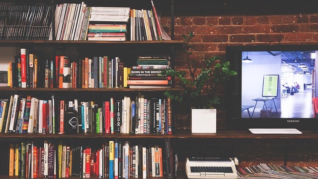 Frustrated man with TV issues in a bright living room, pondering 'Can a Smart TV Work Without Wi-Fi?'