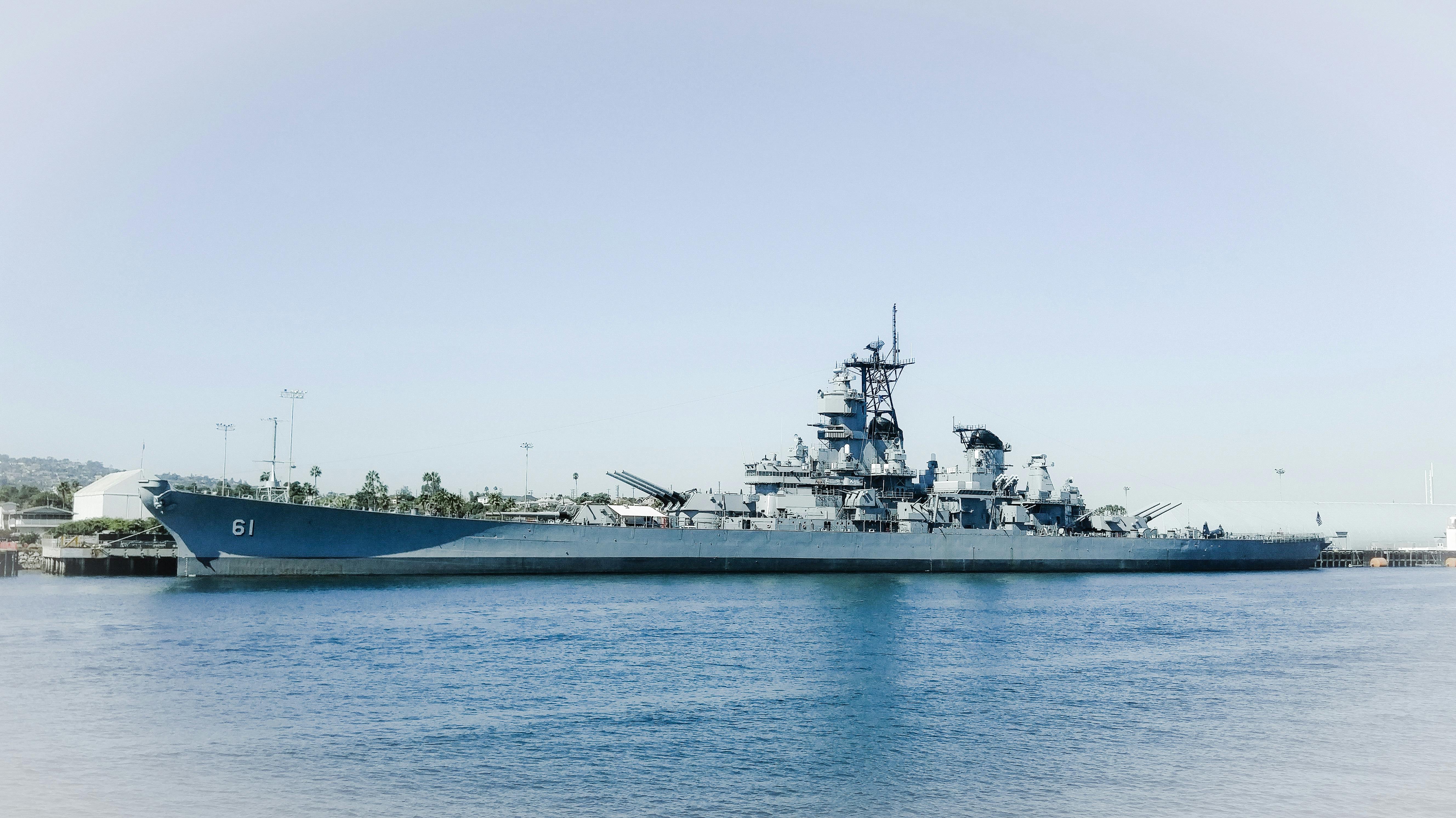 Naval fleet cruising the ocean, demonstrating military jobs.