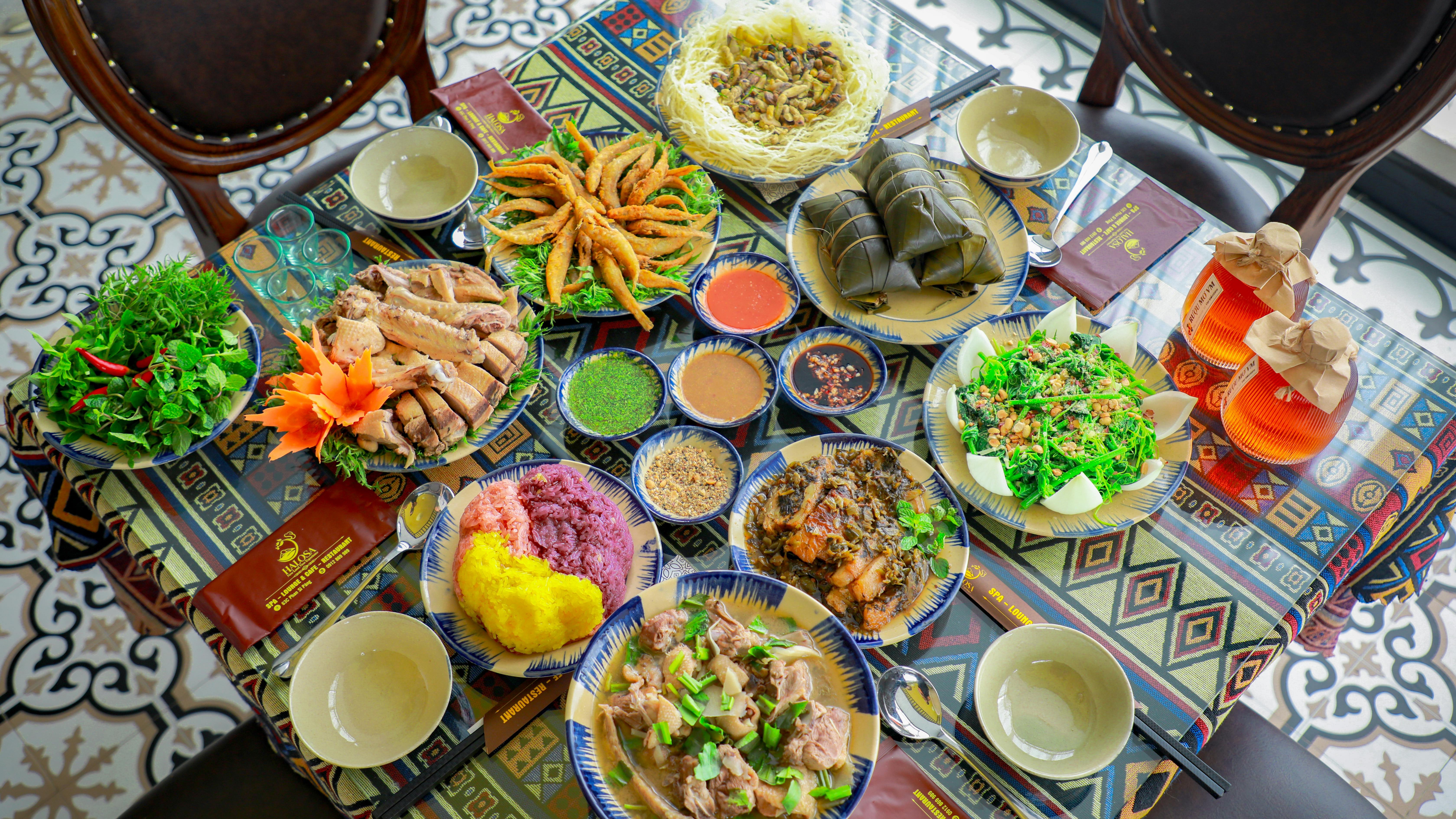 Vibrant array of dishes at a San Antonio festival with hands serving.