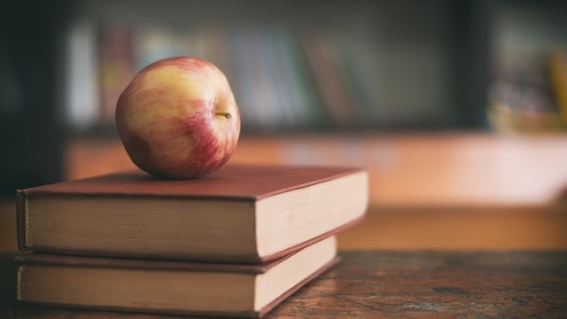 Graduates celebrating success with diplomas and caps - PG&E Scholarships.
