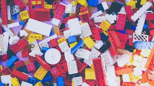 Dynamic Lego characters from Villains Unite in vibrant setting, learning with Lego.