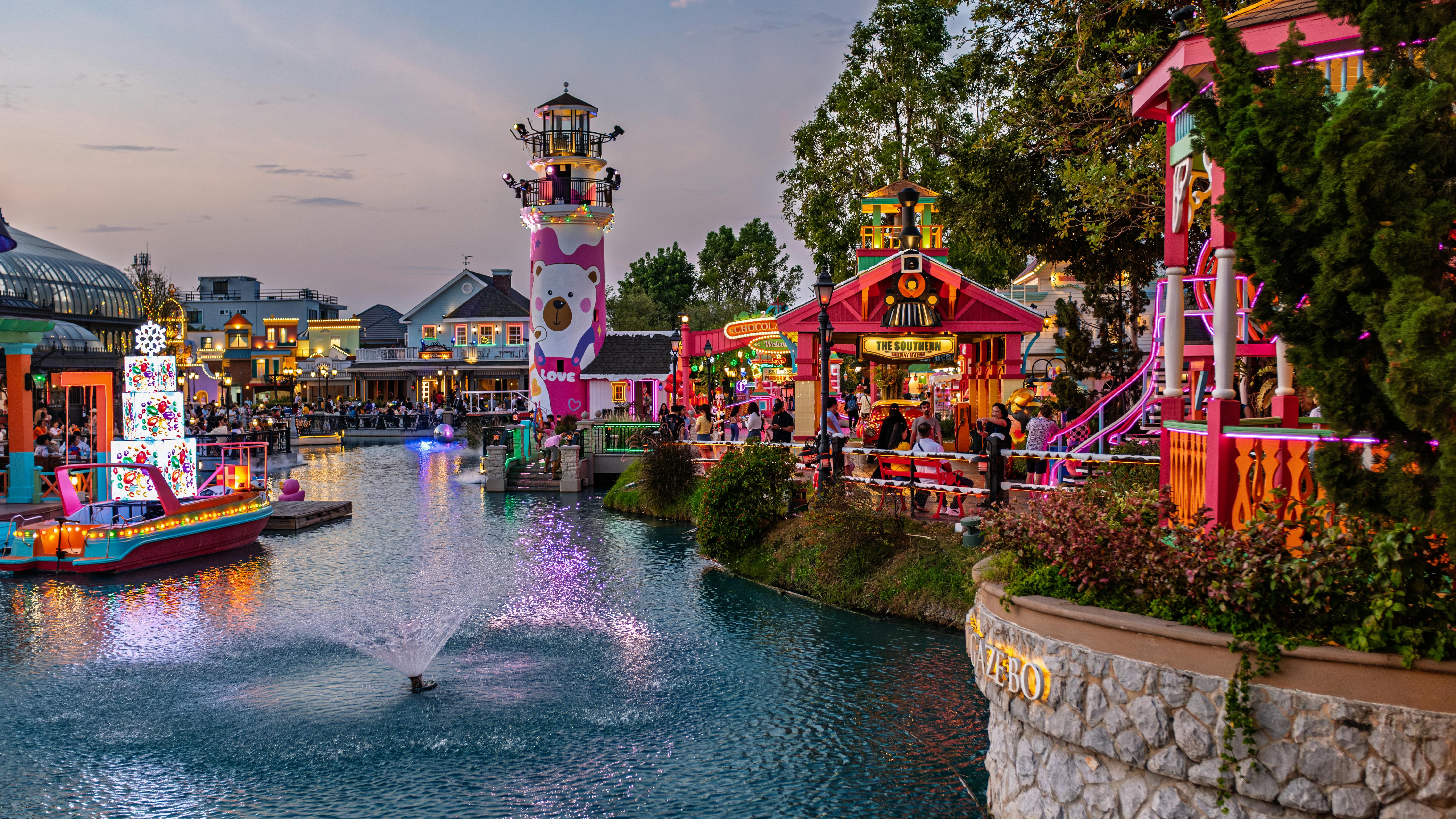 People dining under festive lights in a San Antonio holiday destination.