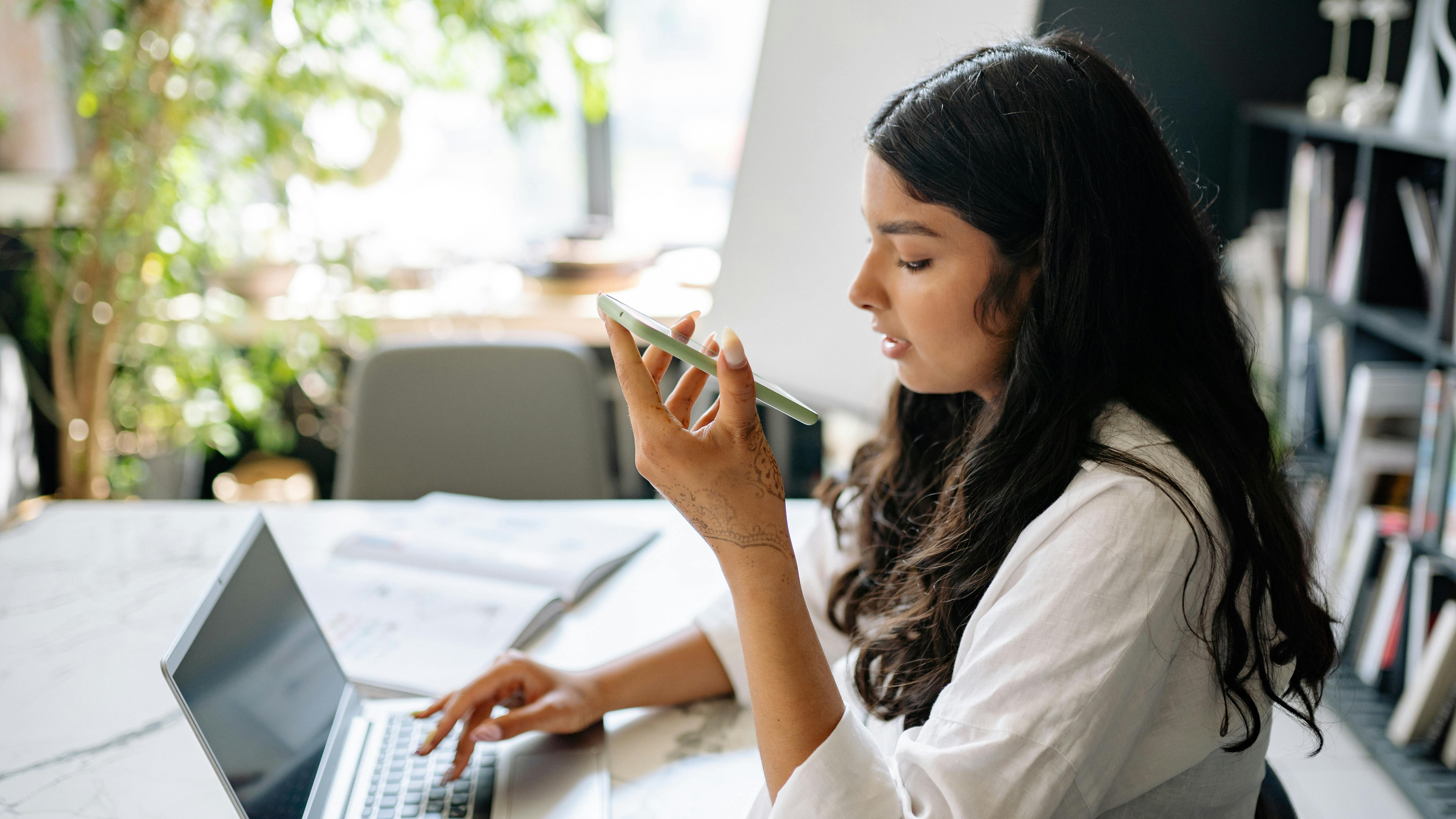 Young woman smiling during an online meeting, showcasing connection at work.