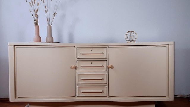 Kitchen utensils and jars neatly organized on a wall shelf.