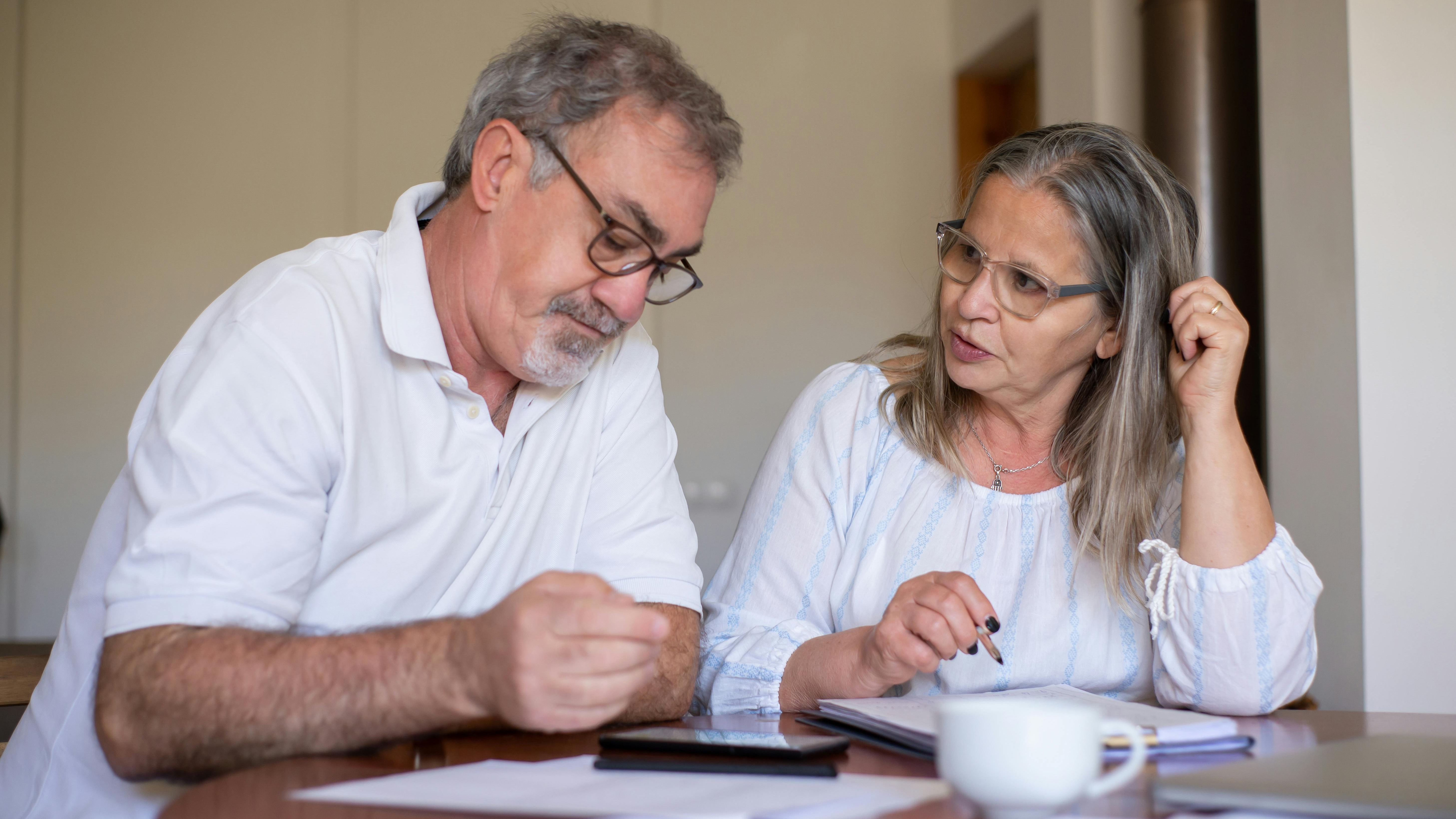 Elderly couple calculating comfortable retirement savings