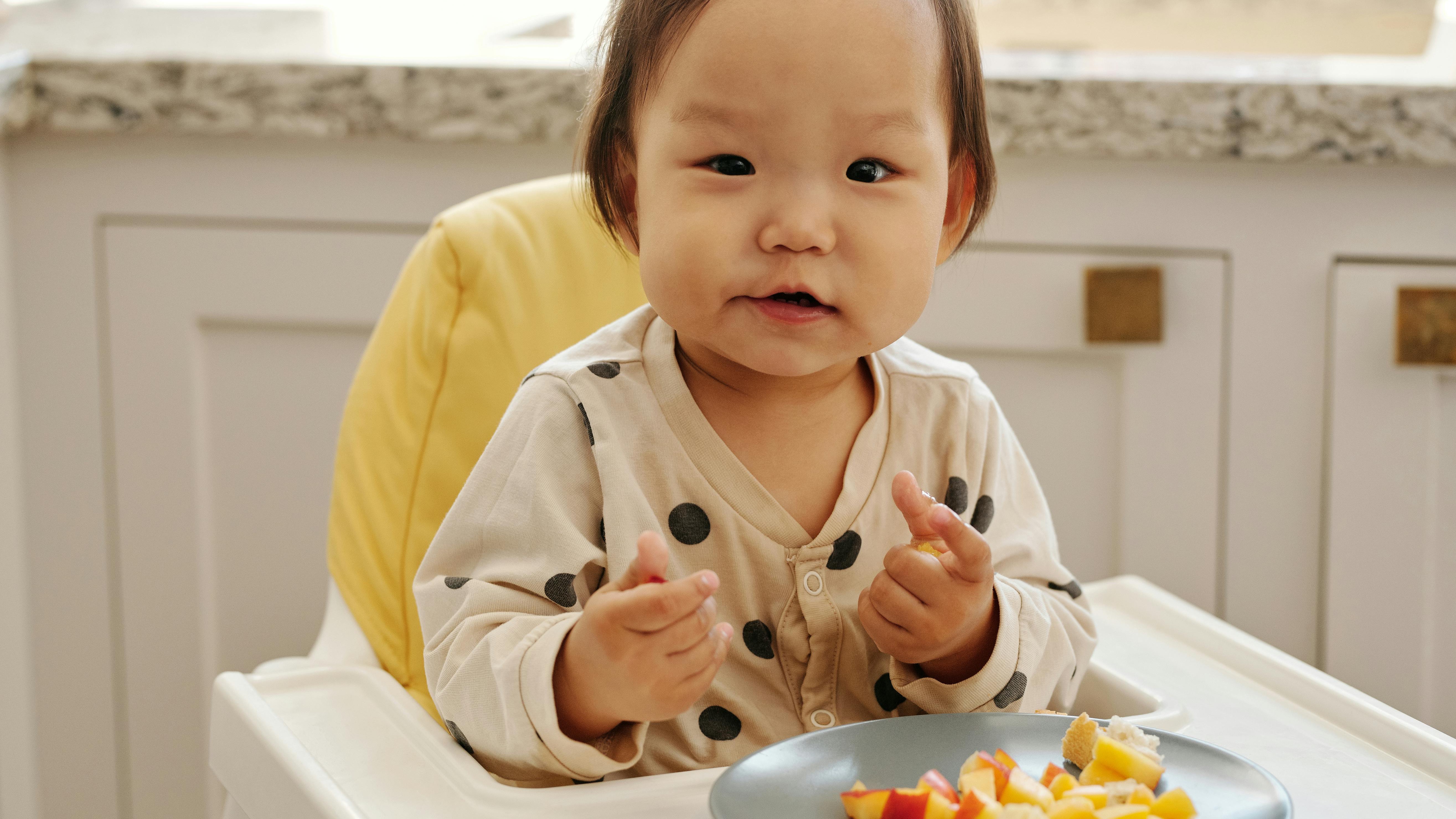Assortment of healthy finger foods for toddlers on a blue background.