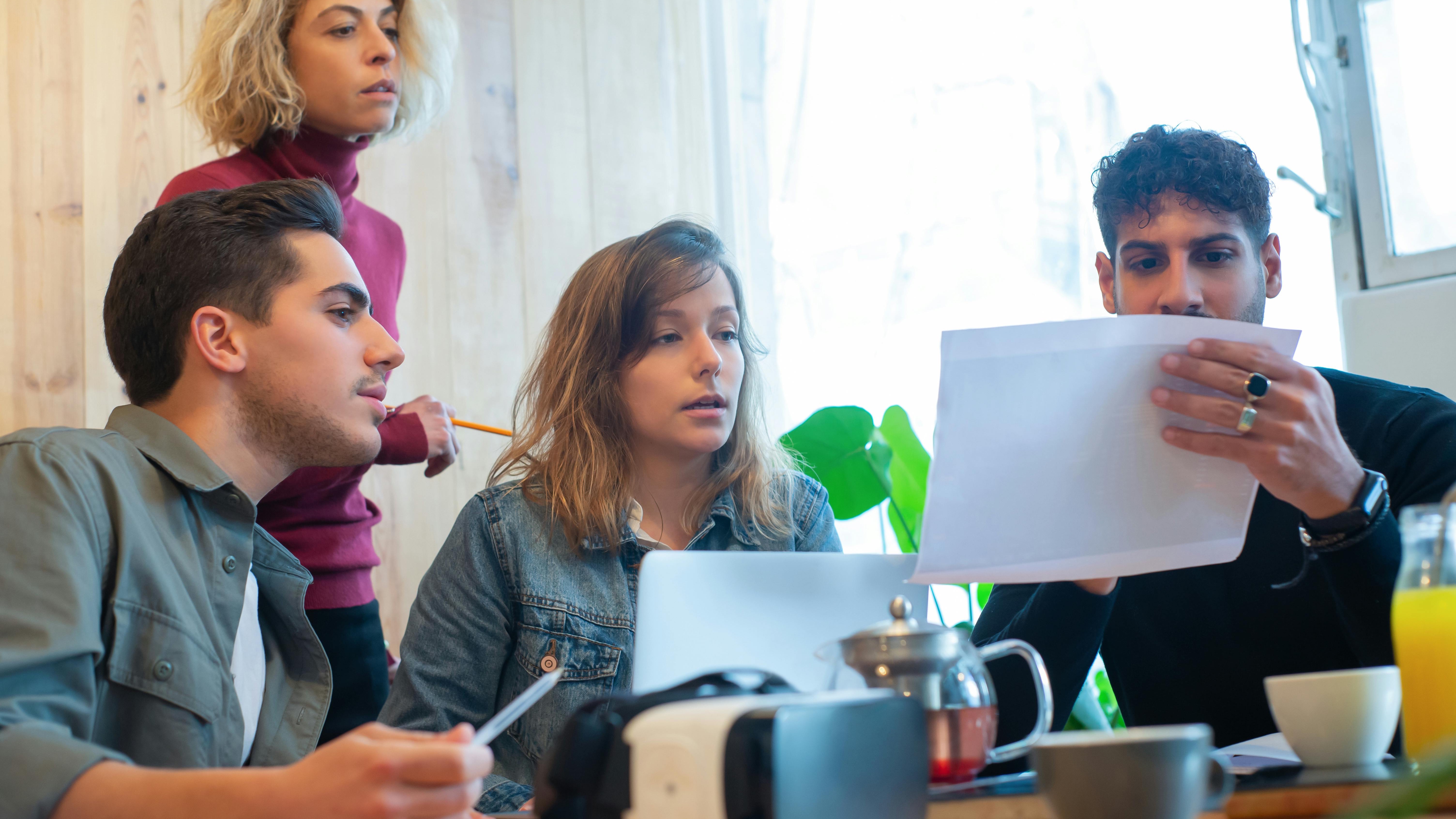 Innovative grabbing tool lifts papers, symbolizing precision in AI teams.