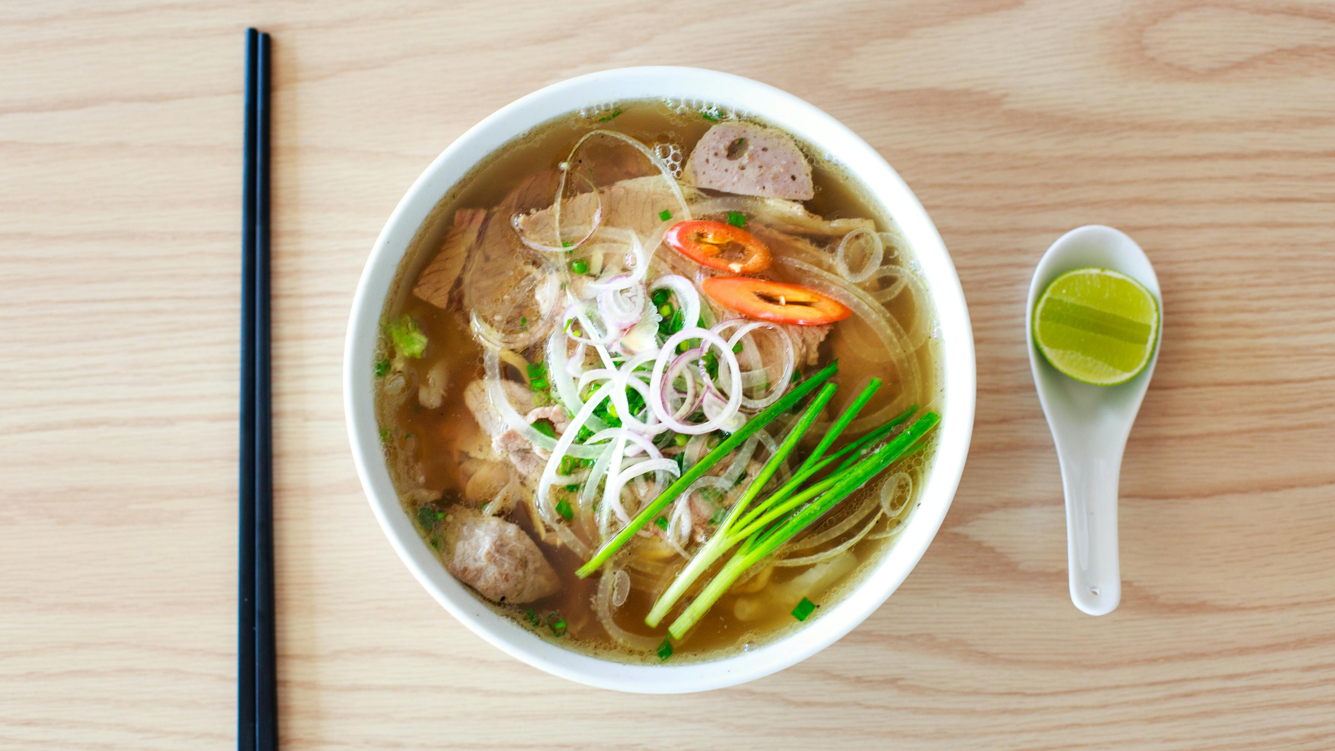 Singhs Vietnamese San Antonio restaurant sign with noodle bowl graphic.