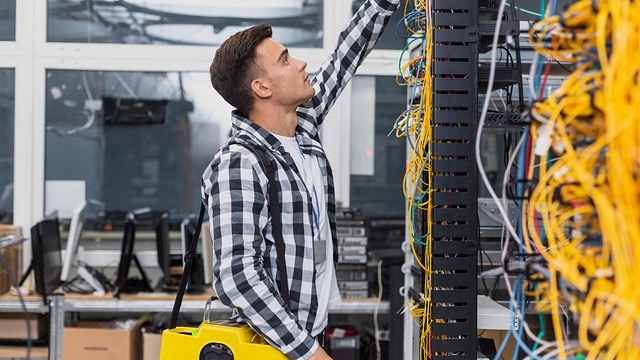 Modern building with company logo, relating to broadband infrastructure funding.
