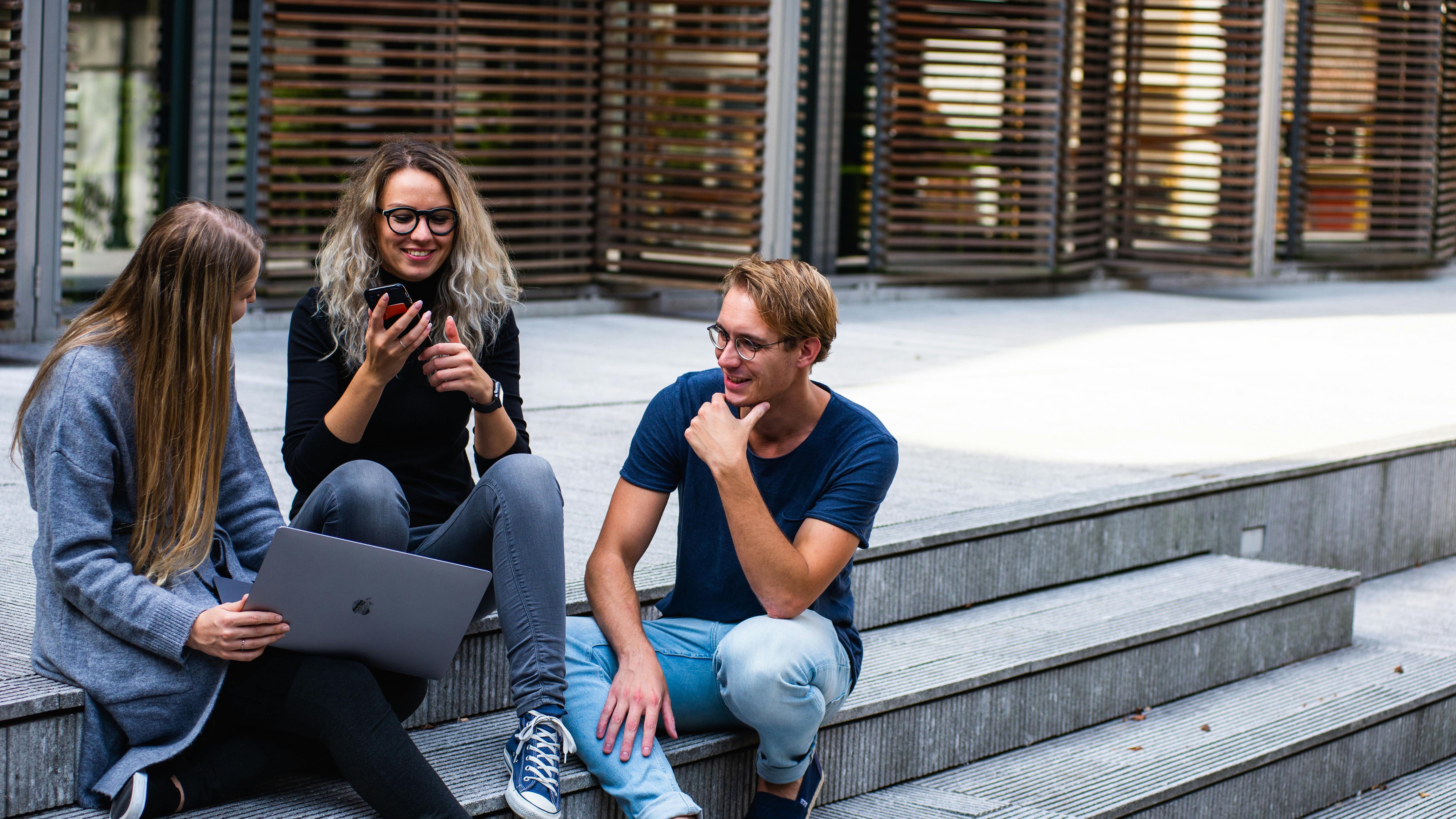 Young man smiling confidently, AI startups innovator, neutral background.