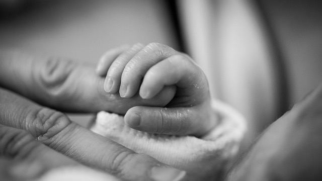 Happy baby with mother, exploring popular birth months in the U.S.