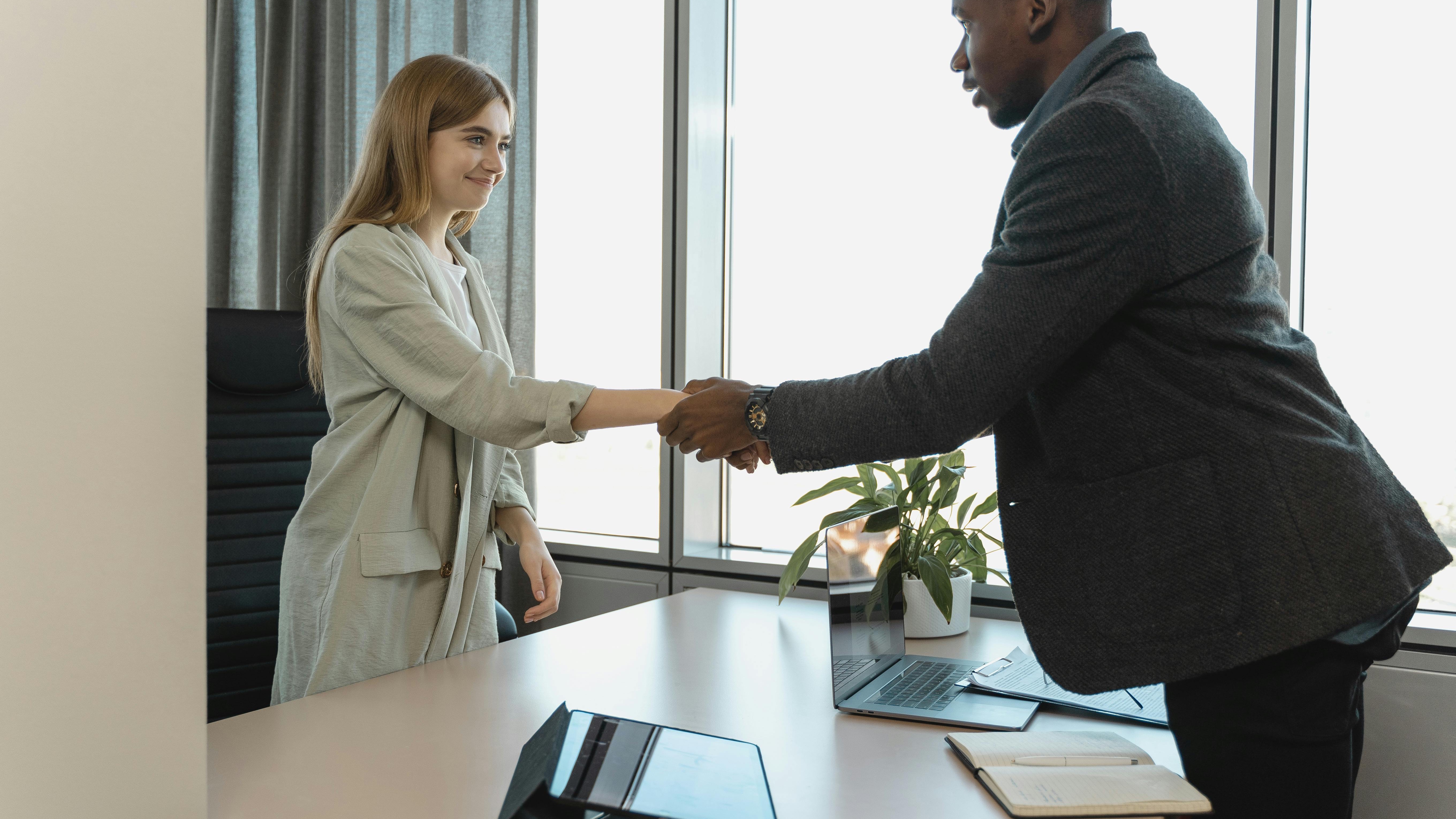 Professional office with AI chat and code on screens showcasing AI in recruiting.