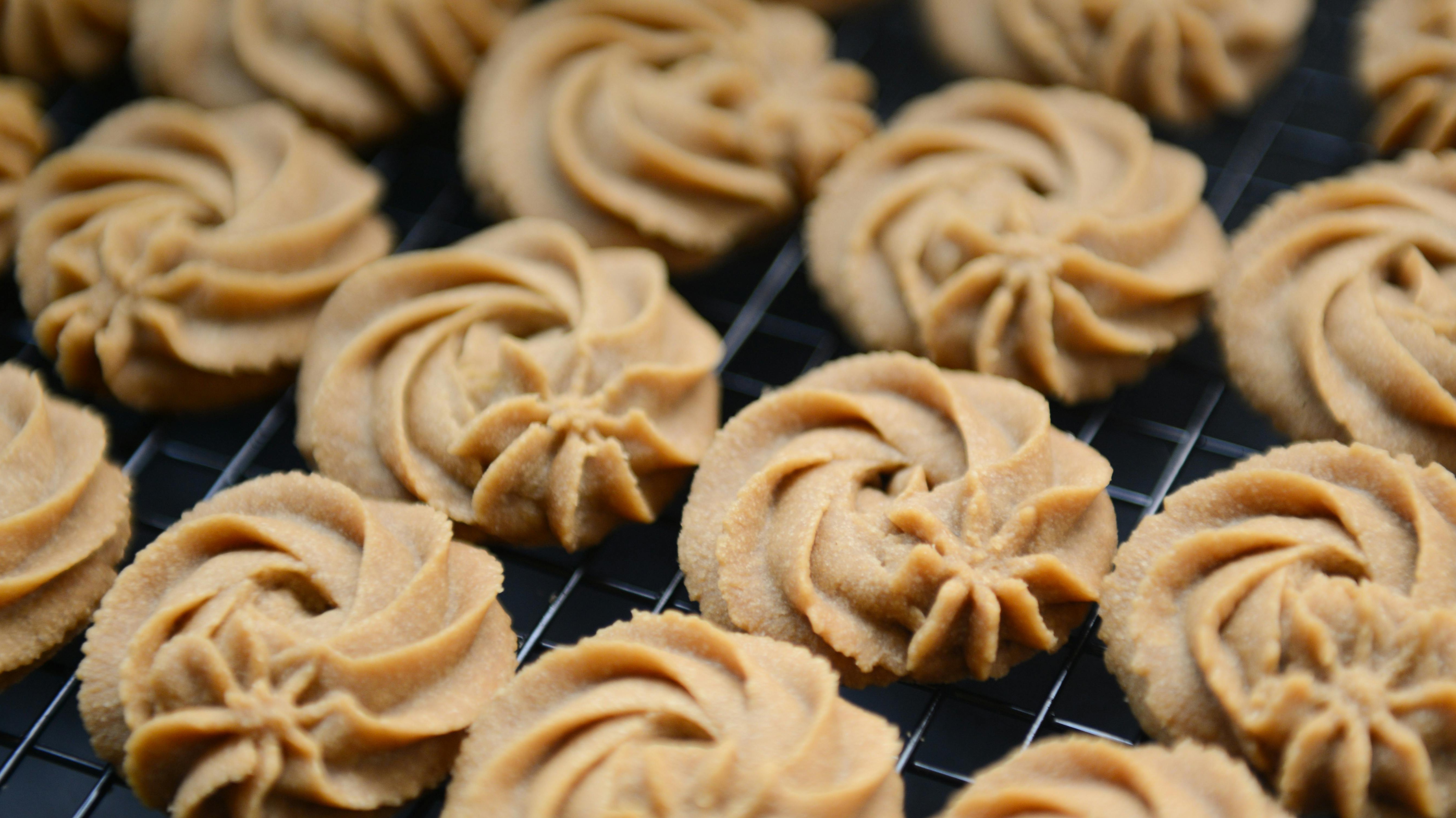 Cherry chocolate chip cookie held above cooling rack.