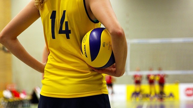Omaha Supernovas players in an intense volleyball match, vibrant action.