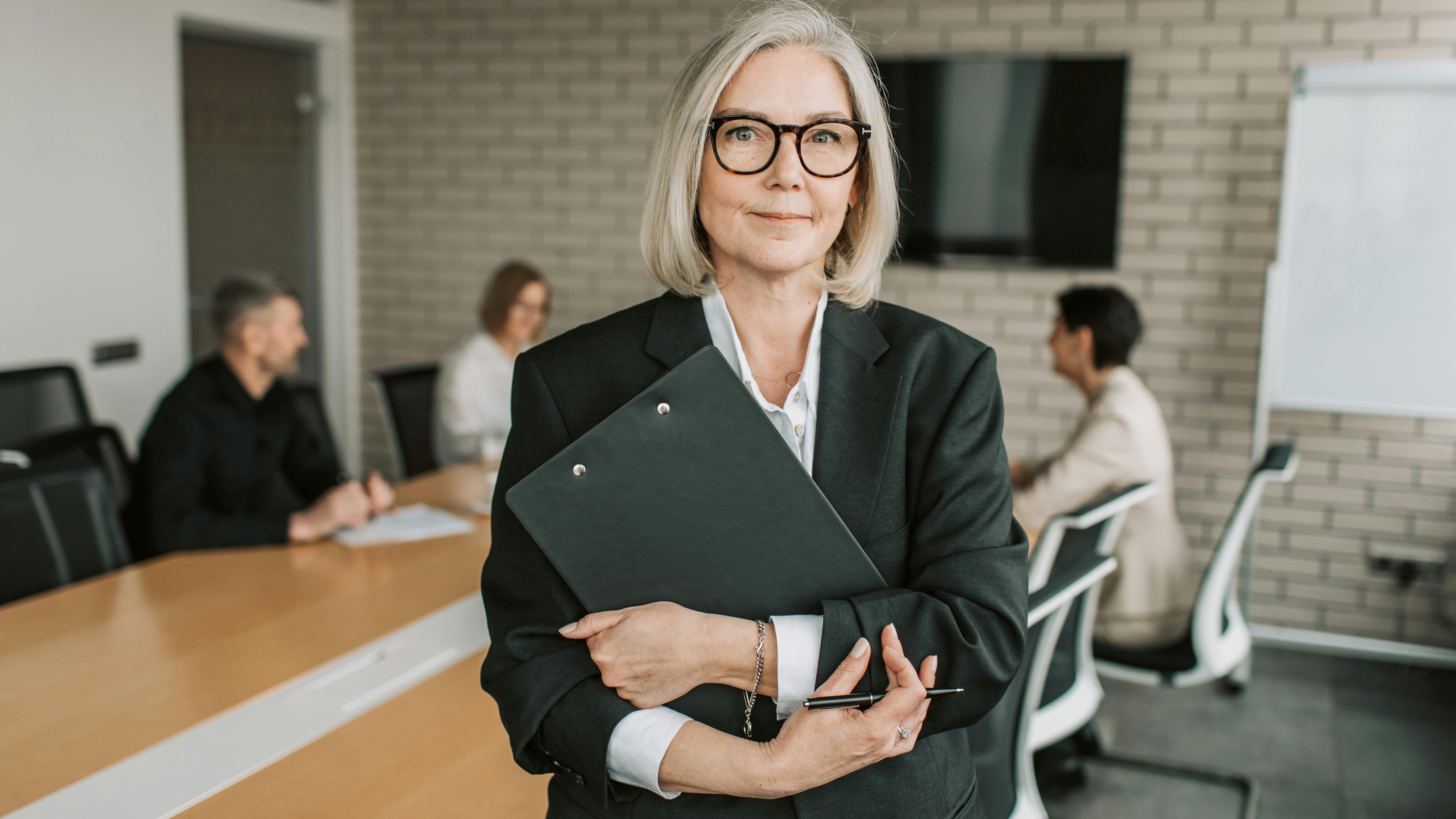 Diverse hospitality team discussing people-first leadership principles in a modern hotel lounge.