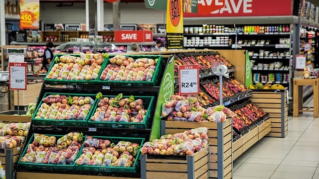 Family grocery shopping on a budget in a bright store aisle.