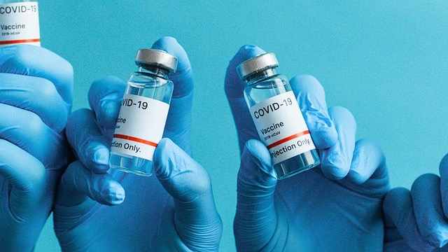 COVID-19 vaccine syringes highlighting vaccine exemptions in hiring practices.