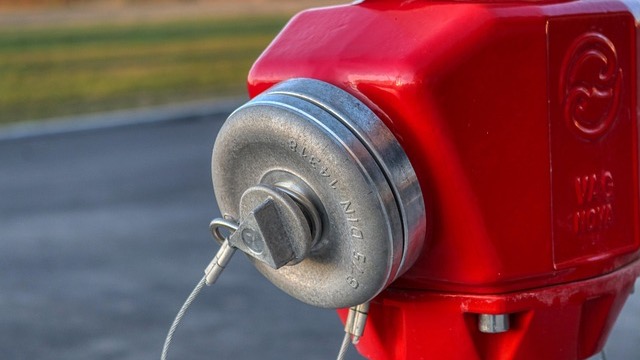 Girl enjoying hydrant party in Omaha, splashing through water