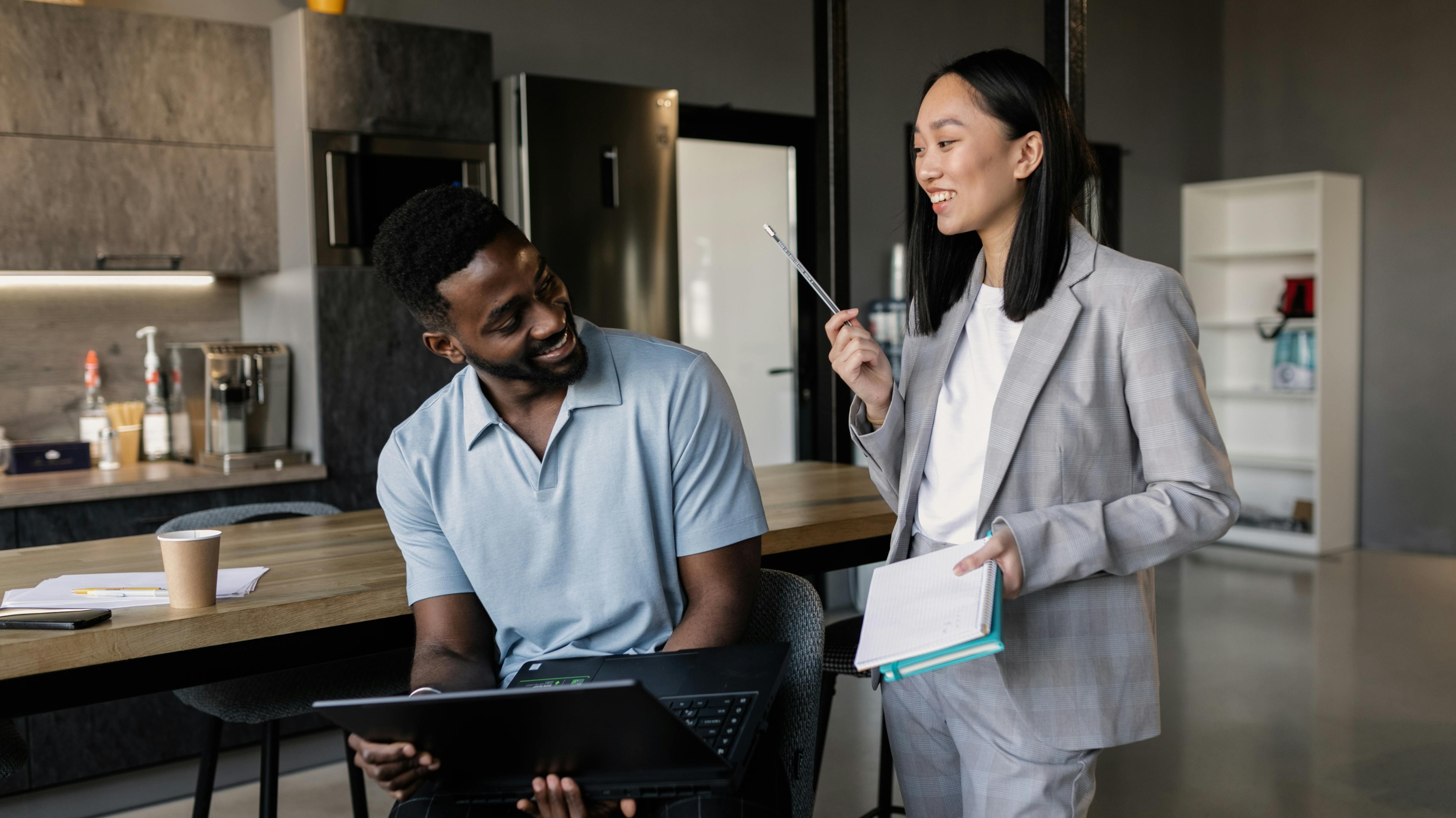 Stressed worker in office with drink, exploring recovery-friendly workplaces.
