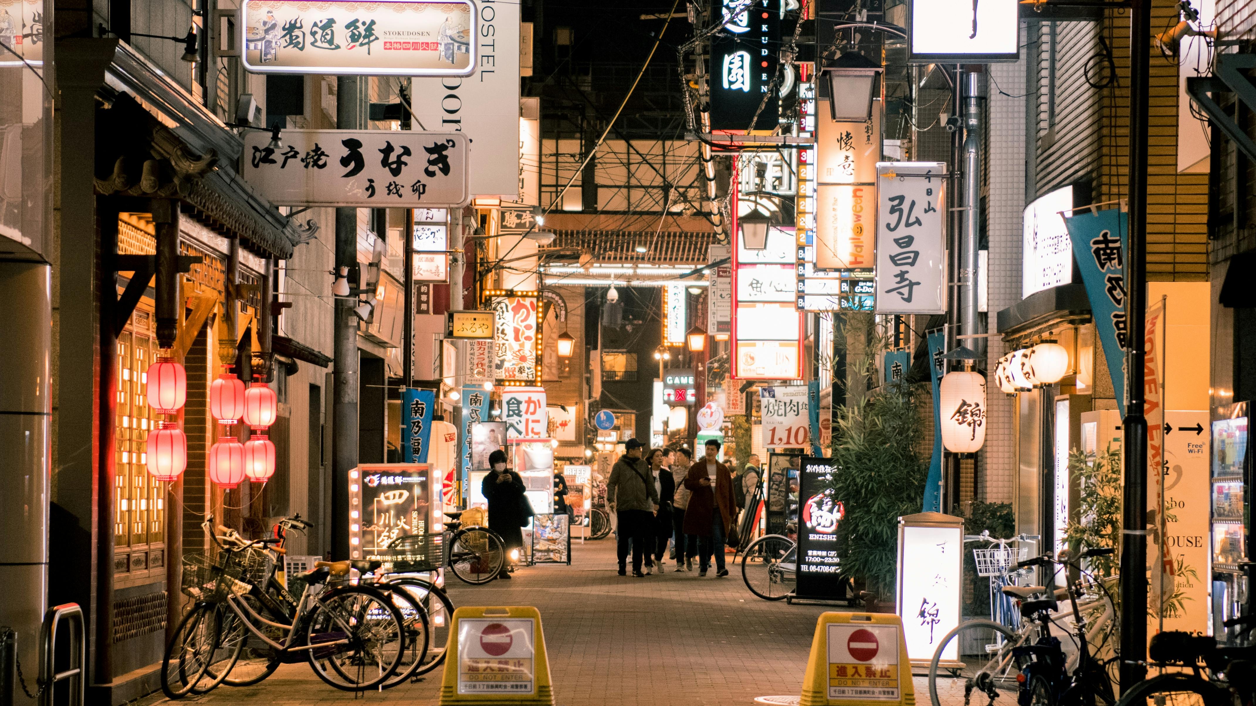 Vibrant Shibuya crossing at night showcasing dynamic city life and billboards.