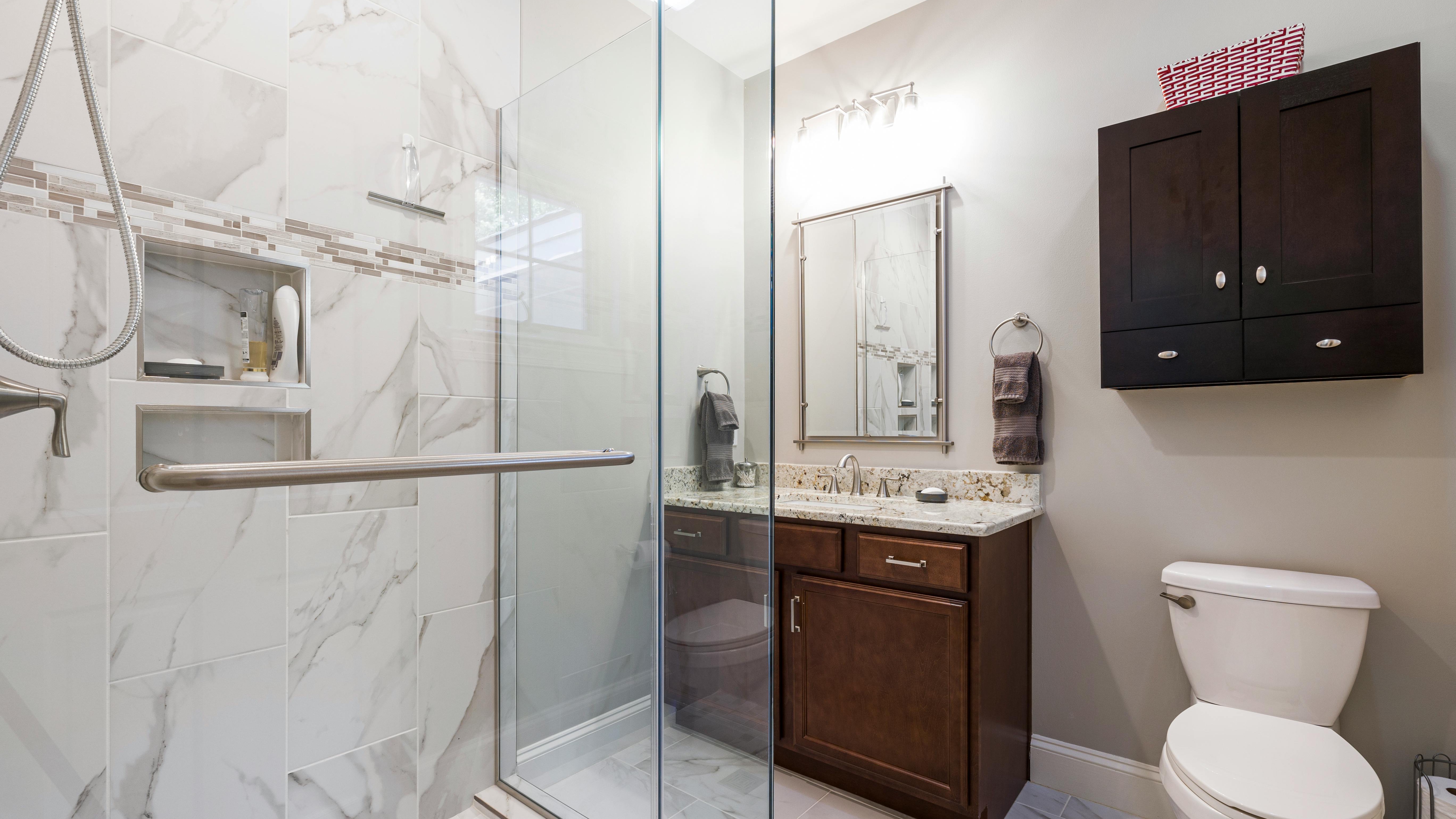 Modern bathroom with lighting upgrades and white decor.