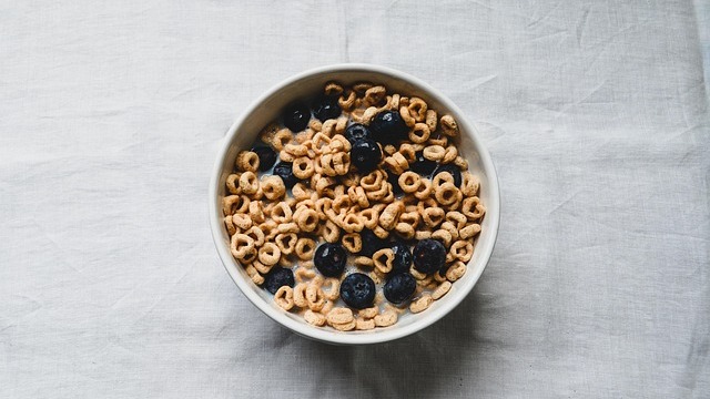 Assorted healthy snacks for kids neatly arranged on a white background.