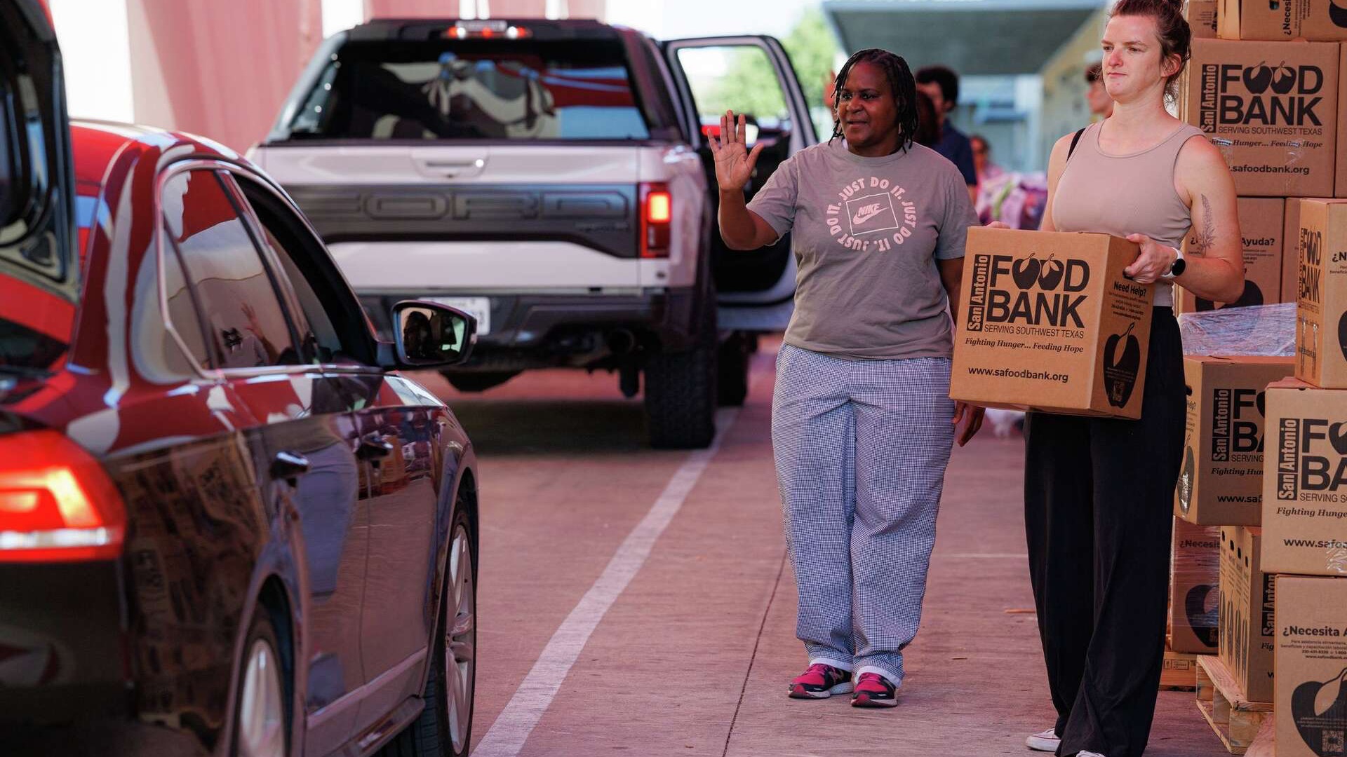 San Antonio community events volunteers in red shirts smiling in a colorful shop.