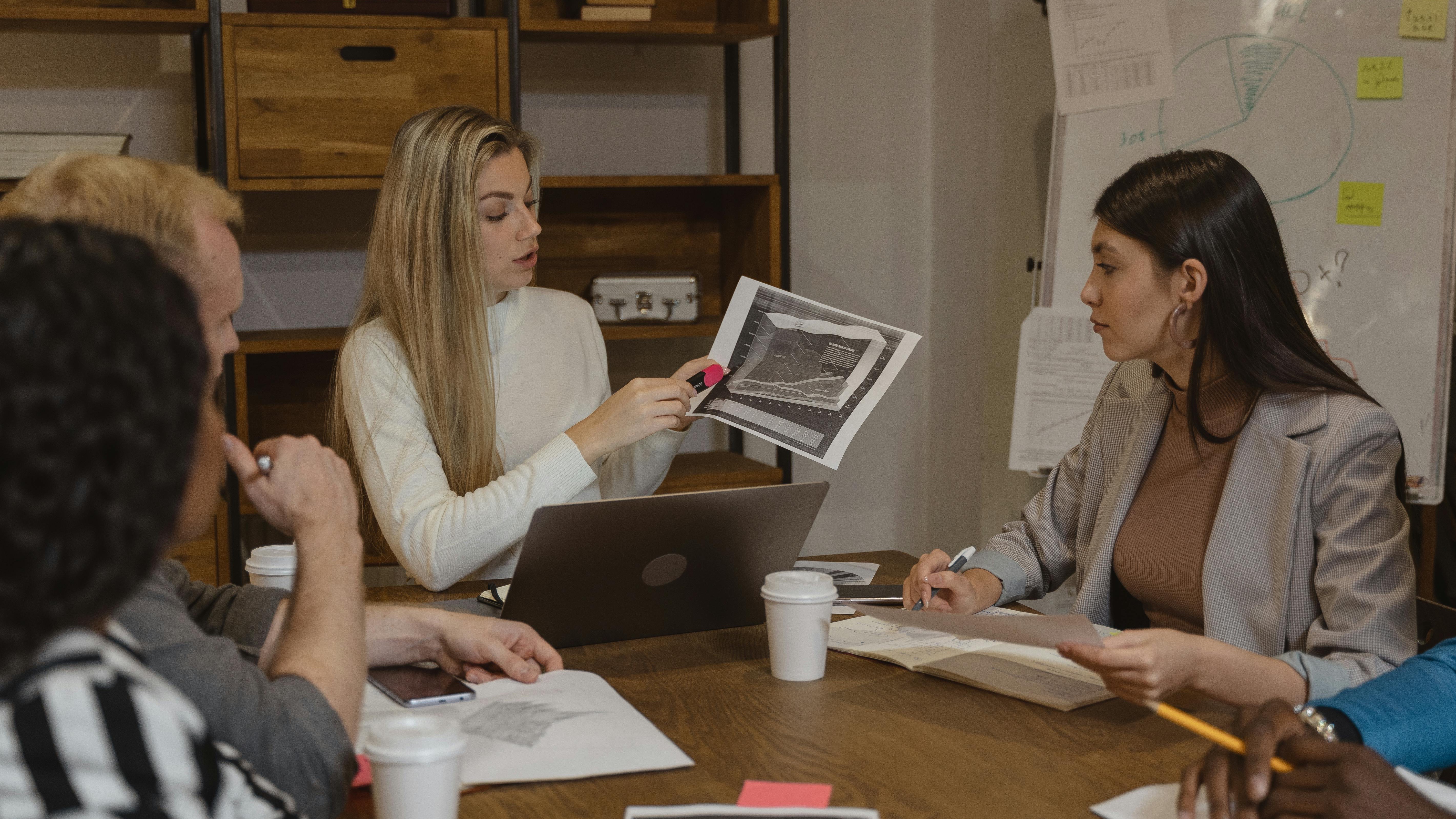 CHROs discussing data in modern office, teamwork focus.