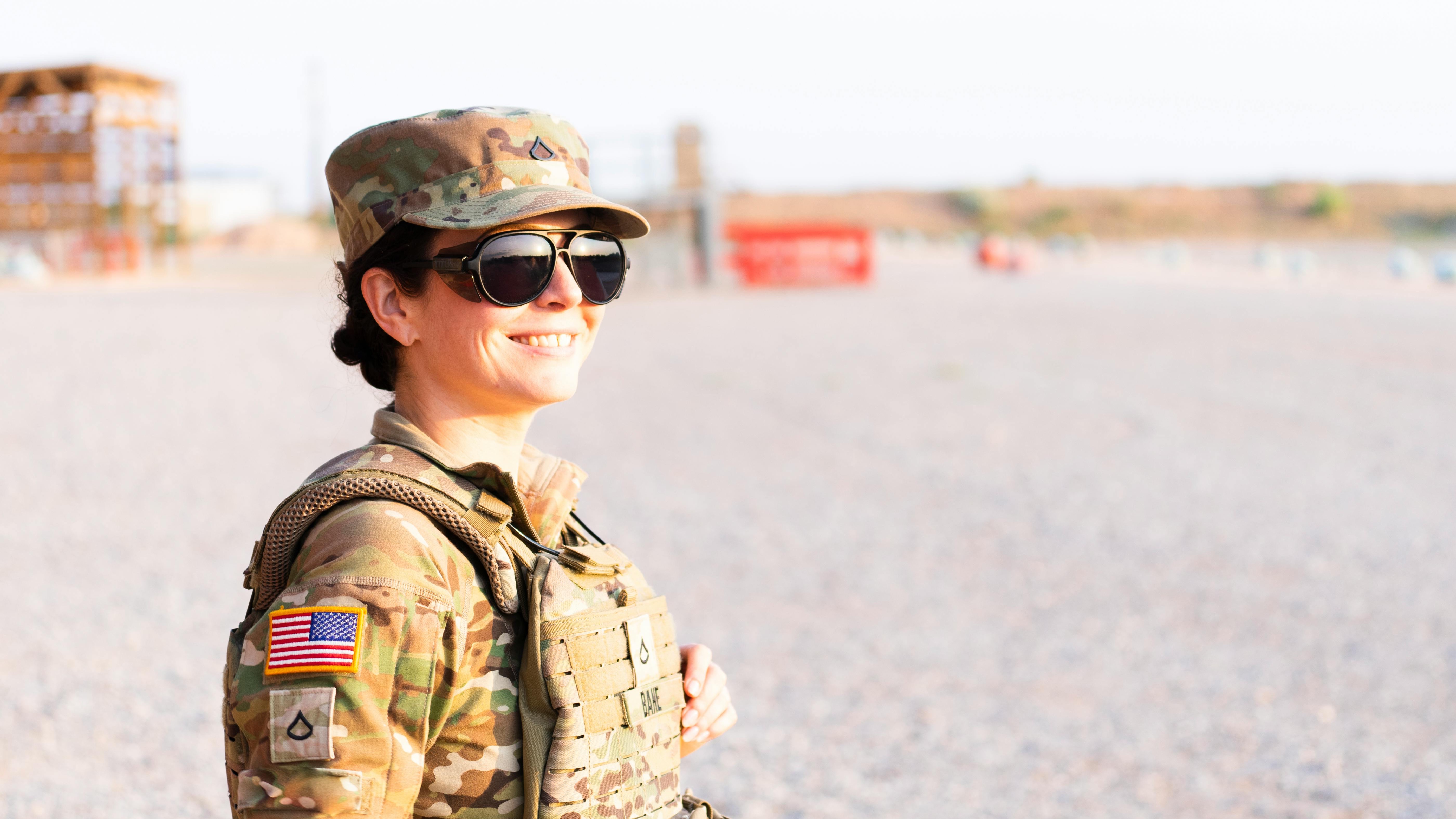 Smiling woman supporting veterans in the workplace, outdoors.