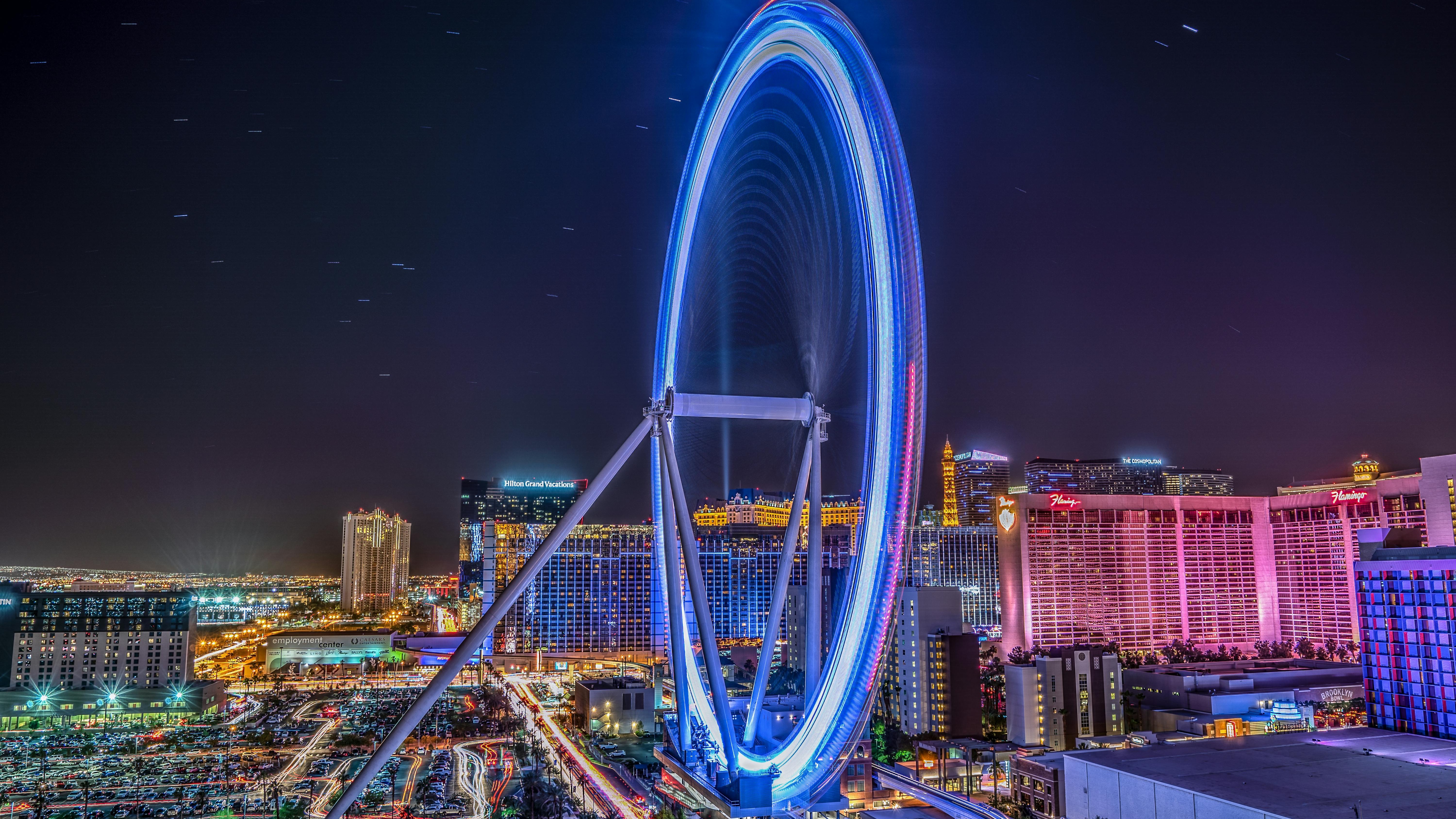 Illuminated hotel and casino at night with vibrant lights and city skyline