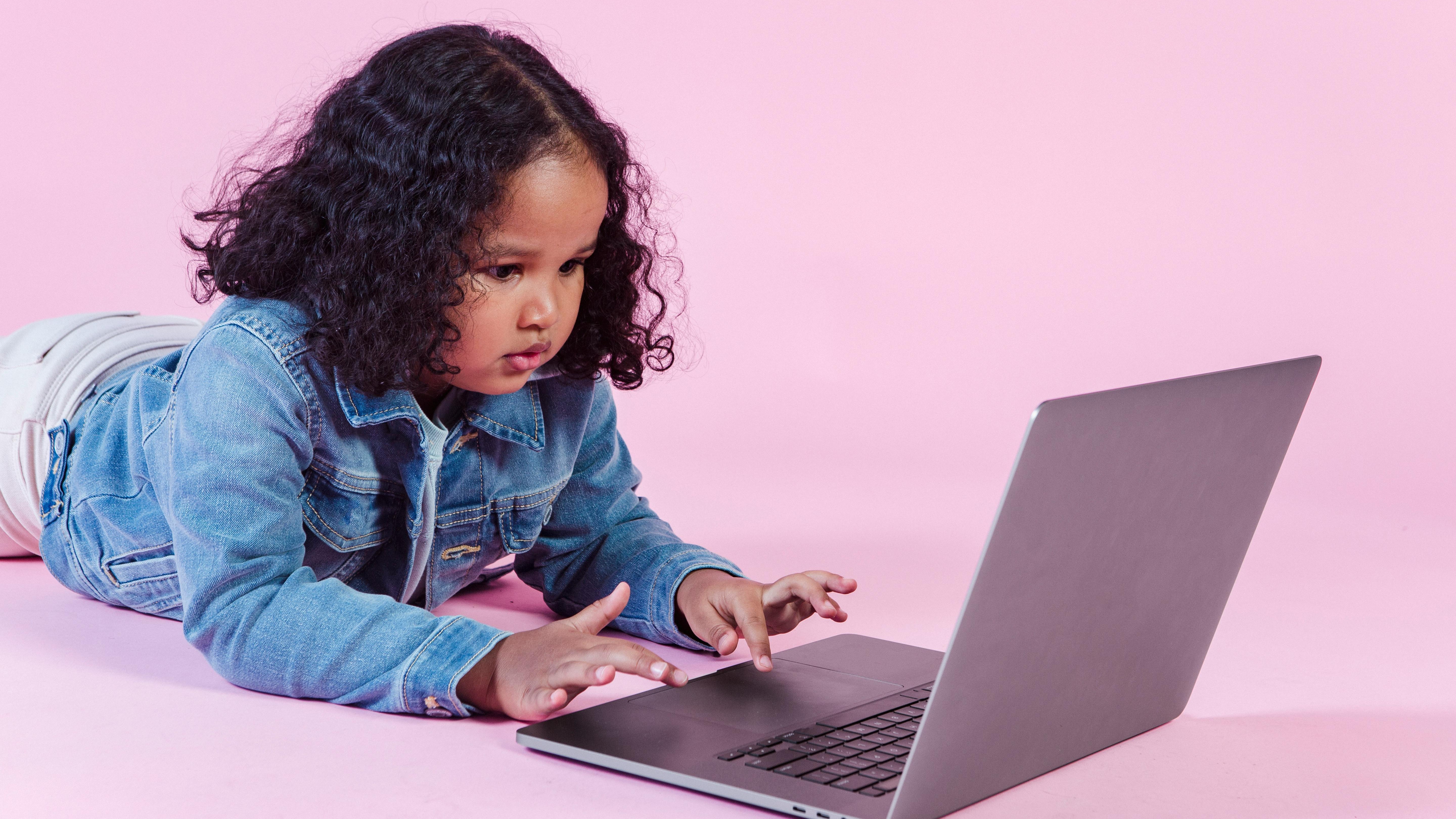 Child engaging with AI-generated kids videos on a screen.