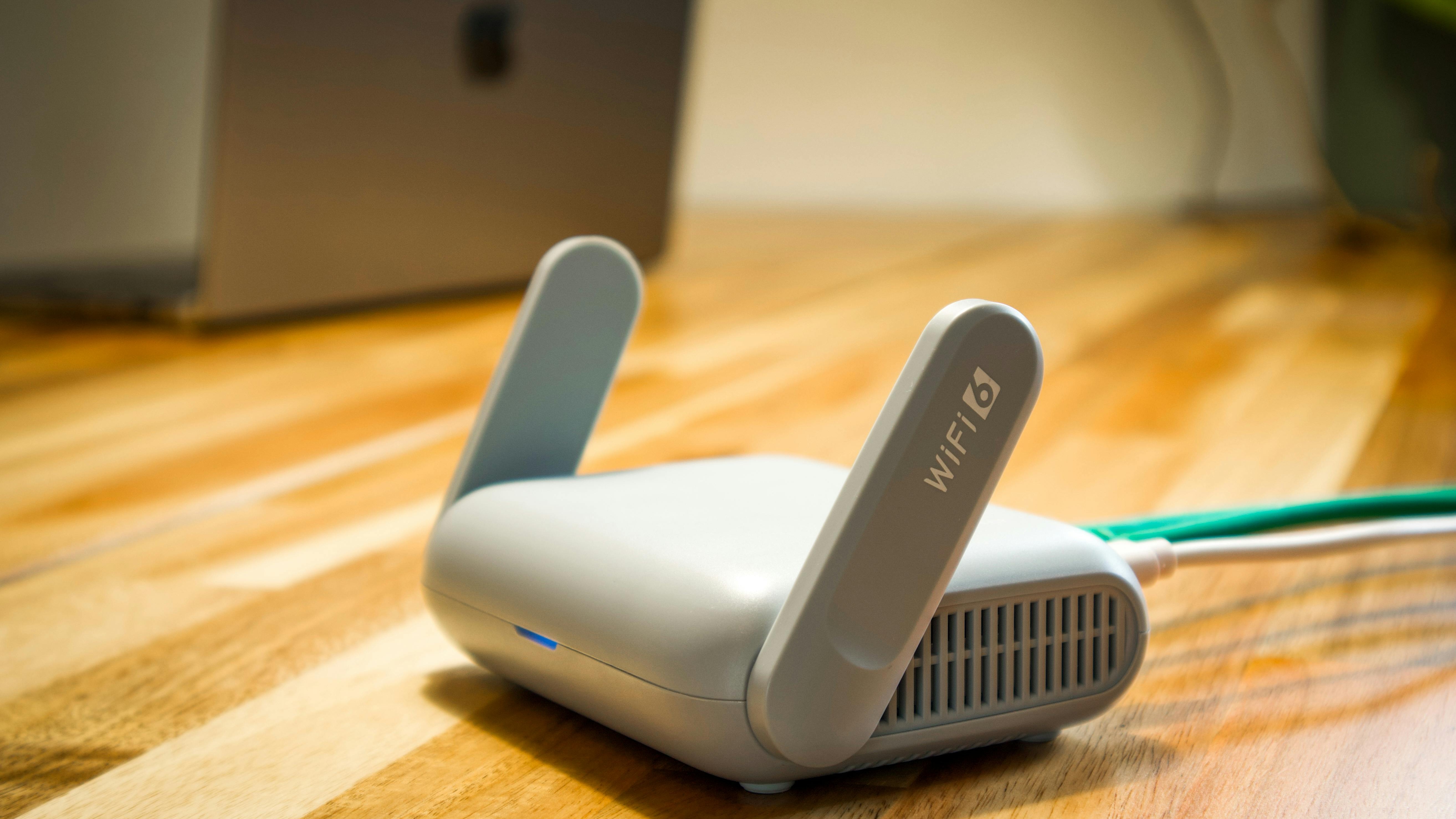 Sleek white mesh routers on gradient pastel background.