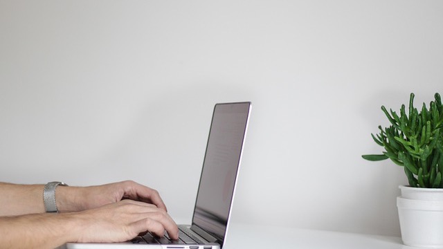 Router and person adjusting settings to improve home Wi-Fi speed