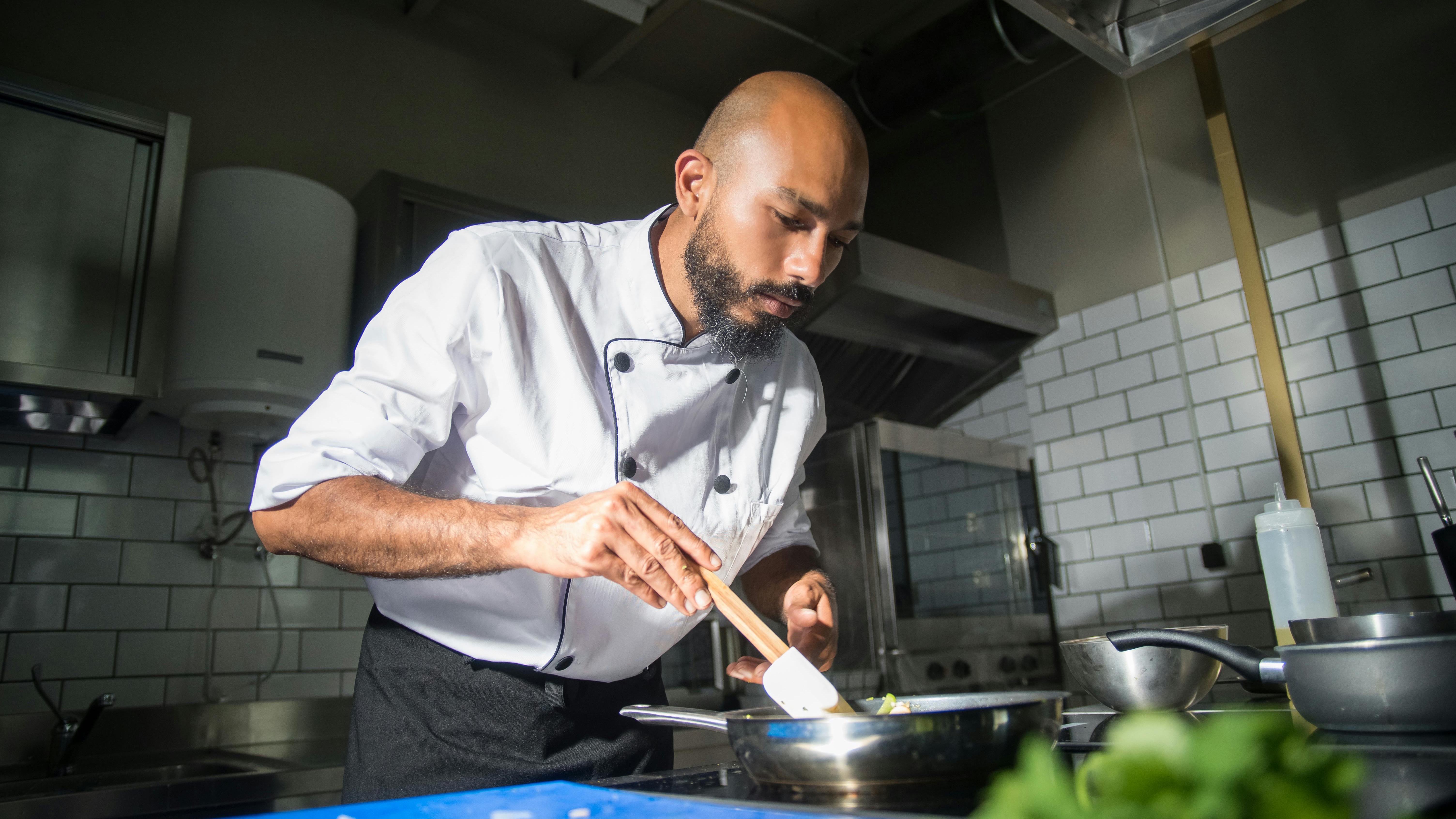Two men in stylish black attire inside a San Antonio restaurant.