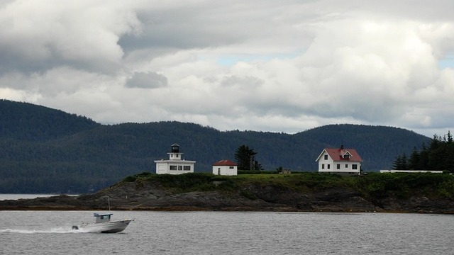 Scenic harbor town in Alaska with boats and homes.