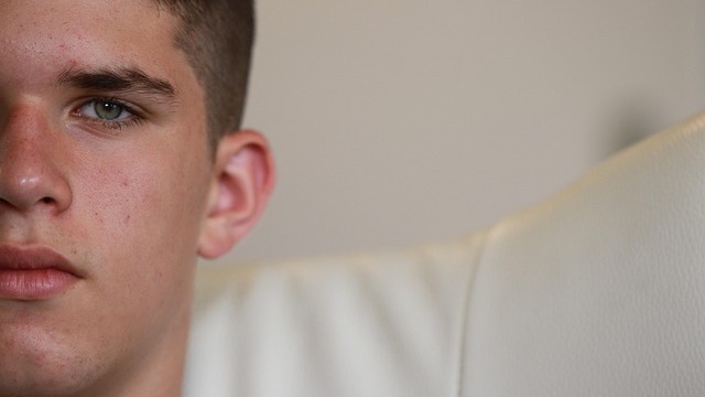 Contemplative teenage girl in close-up profile, deep in thought.