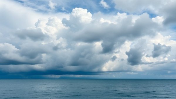 Dramatic ocean view with cloudy sky and calm water