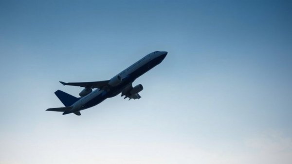 Airplane ascending in blue sky, symbolizing travel technology.