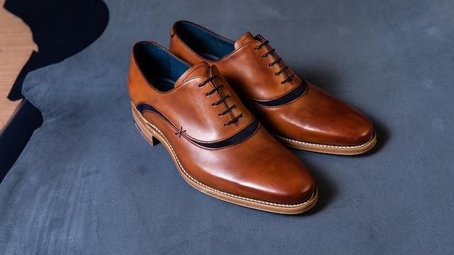 Artisan crafting shoes in workshop redefines luxury.
