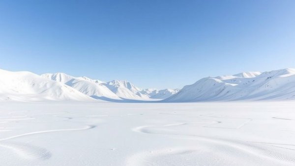 Snow-covered mountains in Svalbard under a clear blue sky.
