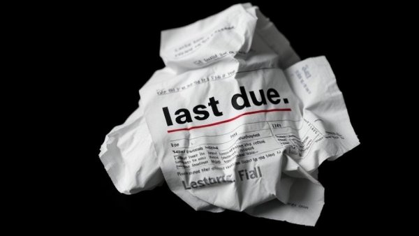 Crumpled overdue bill illustrating how to go paperless.