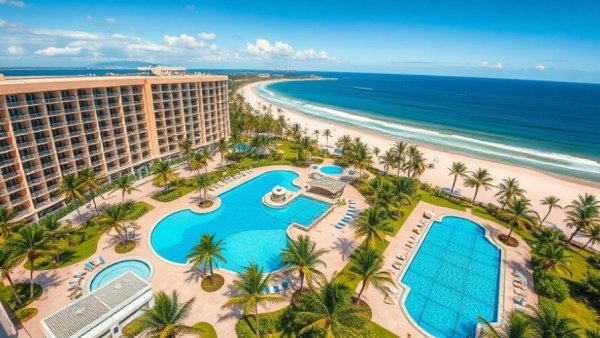 Luxurious beachfront hotel with palm trees and ocean views in popular destination.