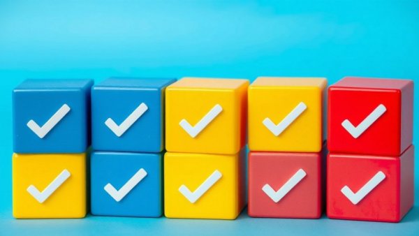 Colorful check marks on cubes symbolizing approval.